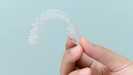 Patient holding clear aligner