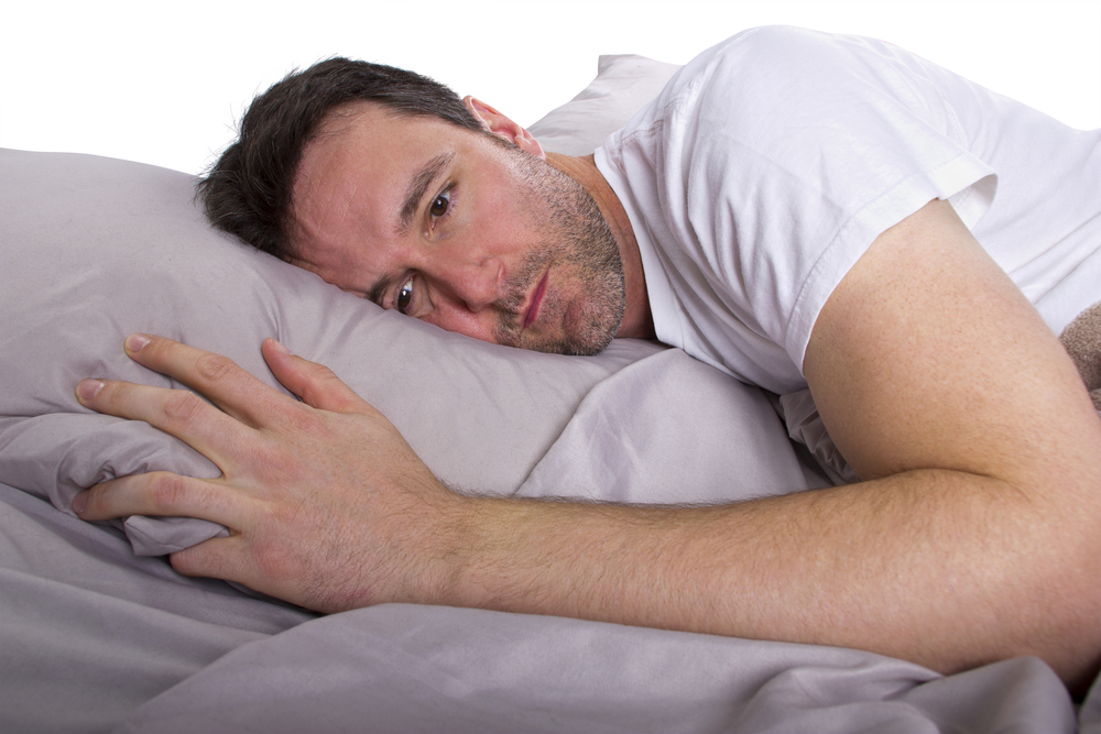 man staying awake at night from sleep apnea